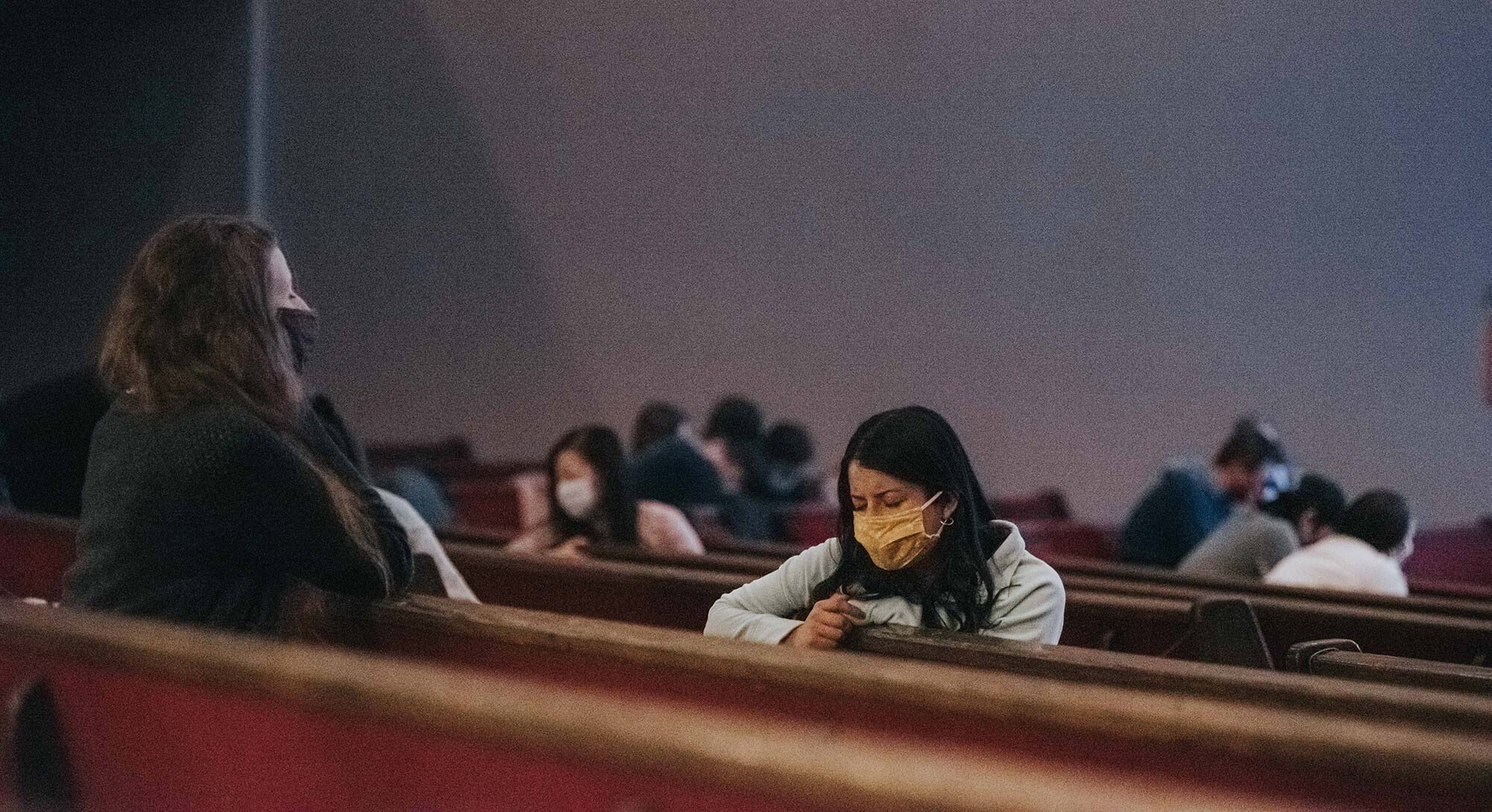 Coquitlam Alliance Church. Two masked women praying in a pew.